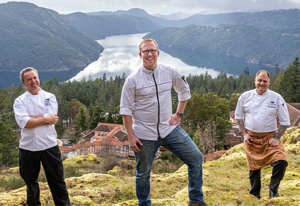 Our chefs smiling in front of the magnificent view of the Saanich inlet.