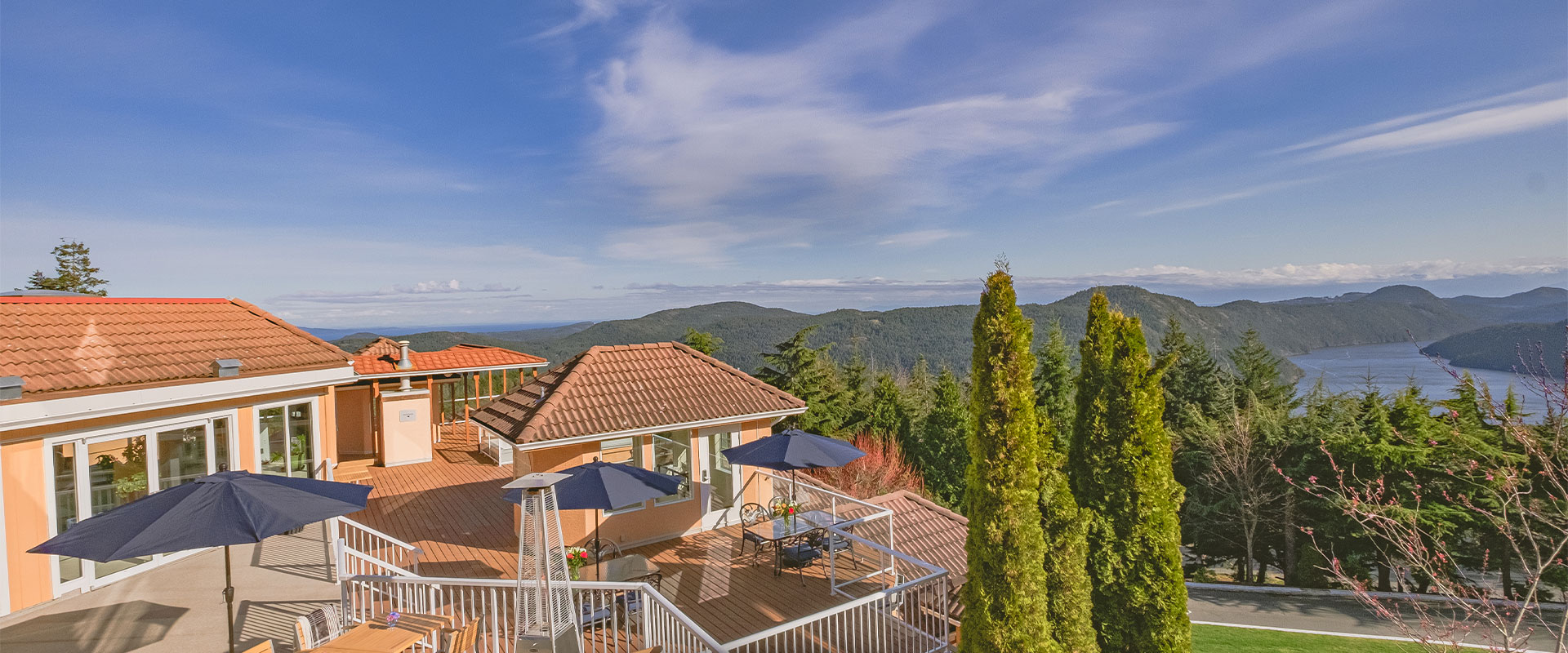 An overhead view of the patios of the Alpina Restaurant with forests and mountains