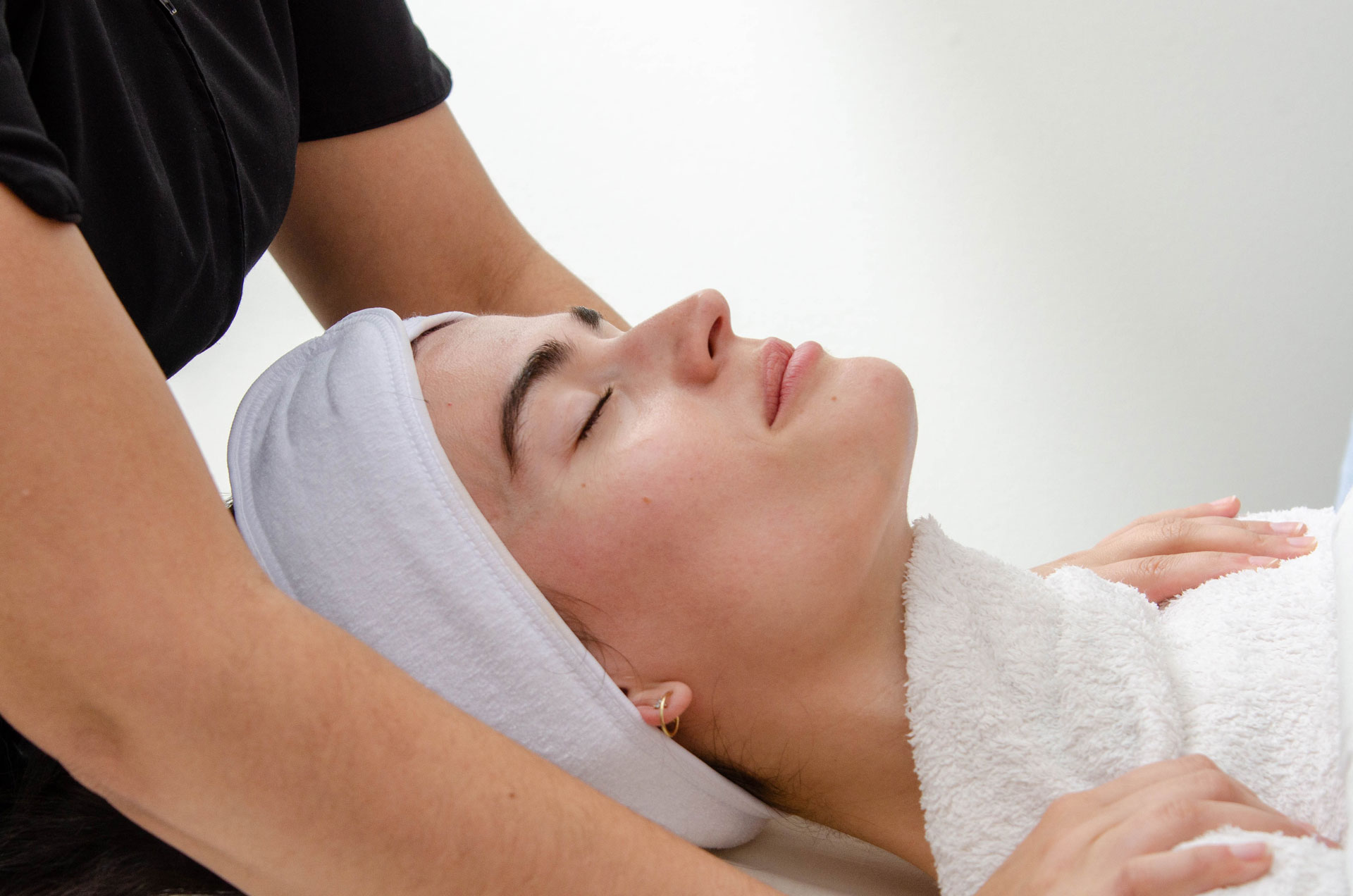 Woman lying down getting an anti-aging facial treatment at the Tuscan Spa.