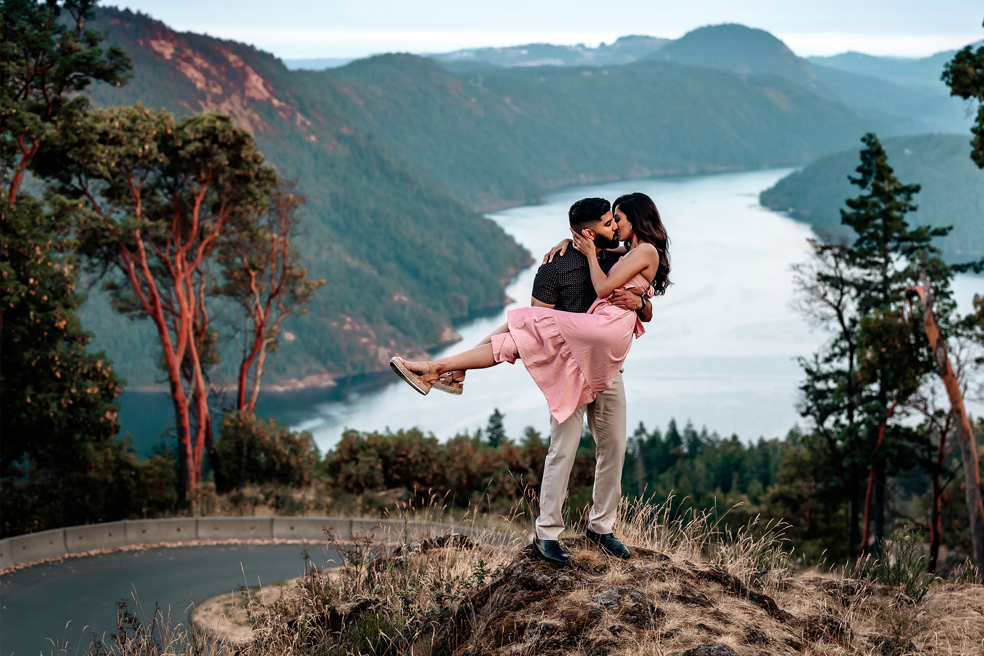 Man carrying wife in loving embrace.