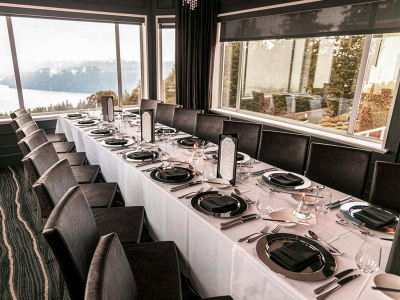A long dining table in the Alpina Restaurant at the Villa Eyrie resort.